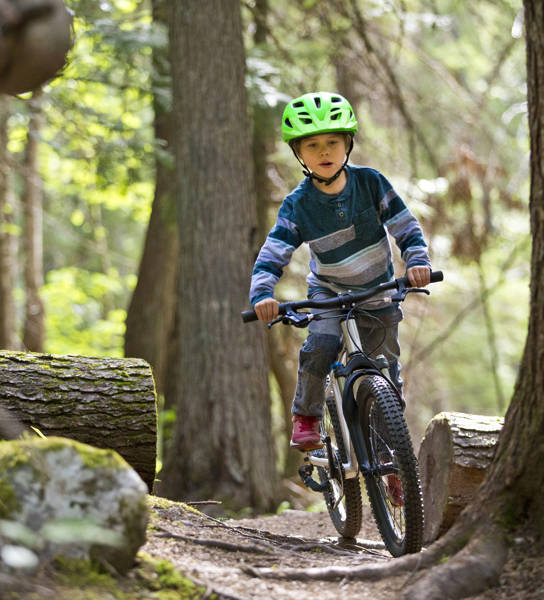 Jongen rijdt met mountainbikefiets door het bos