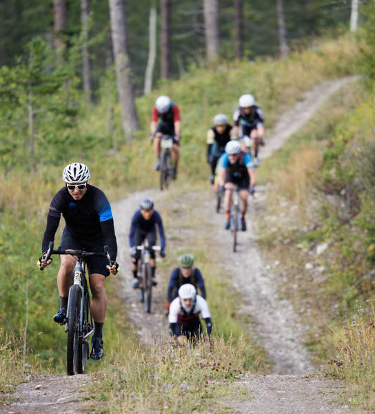 A group of men compete in the 2024 TransRockies Gravel Royale bike race in British Columbia, Canada. The Gravel Royale is a three-day stage race based out of Nipika Mountain Resort near Radium, British Columbia, Canada. The course takes the racers over a combination of gravel forestry and mining roads. (John Gibson Photo / GibsonPictures)