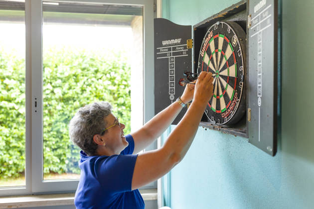 vrouw speelt darts