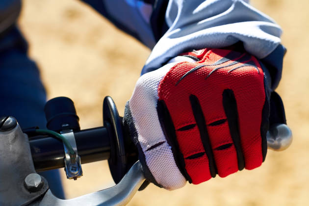 Close-up van een handschoen aan het stuur van een BMX