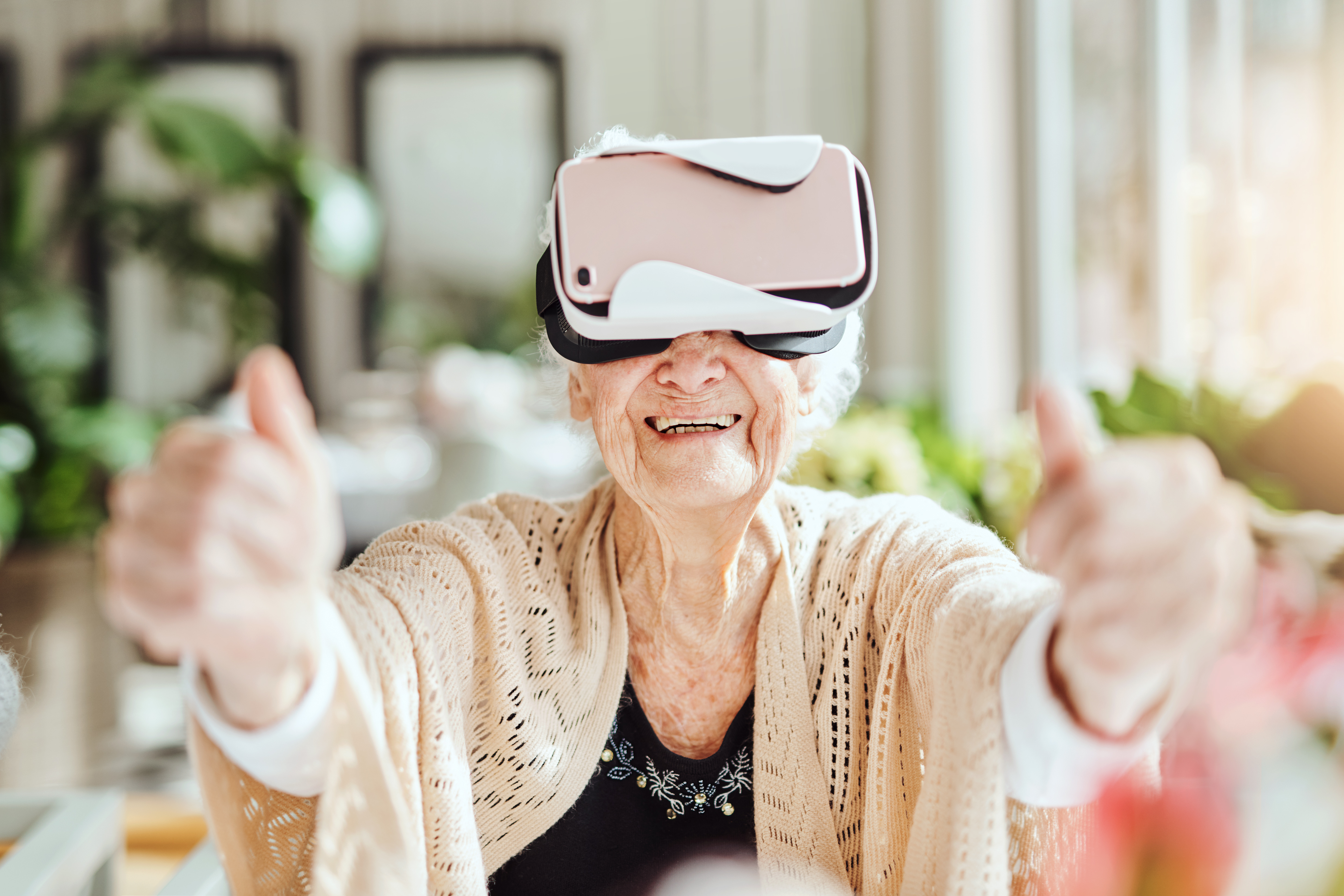 Shot of happy senior women using a virtual reality headset at a retirement home