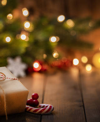 Brown Christmas gift box on rustic wooden table. High resolution 42Mp studio digital capture taken with Sony A7rII and Canon EF 70-200mm f/2.8L IS II USM Telephoto Zoom Lens