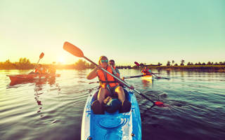 Kayaking and canoeing with family. Children on canoe. Family on kayak ride.