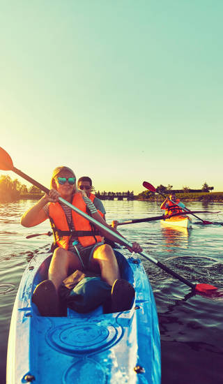 Kayaking and canoeing with family. Children on canoe. Family on kayak ride.