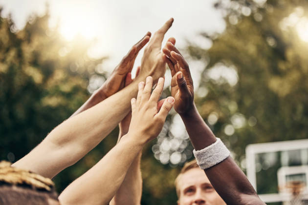 Basketball, hands and team of men high five for outdoor game. Success, diversity and victory in sports for boys goal. Teamwork, diversity and support, friends on basketball court together with coach.