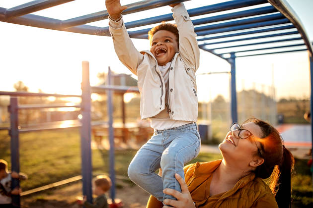 Kid playing with mother in public park