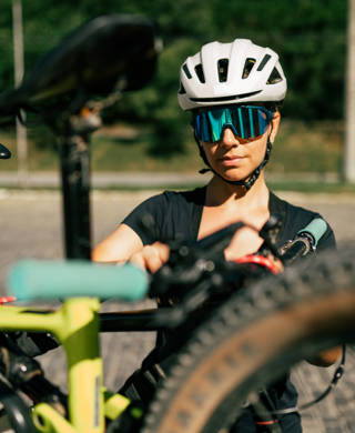 Young woman, putting a bike in the car for a trip