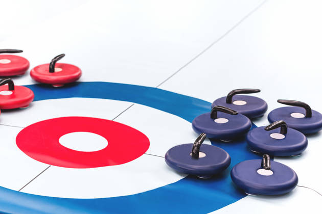 Floor curling sheet with red and blue roller stones for fun indoors or outdoor sport and entertainment activities and kids play. Copy space
