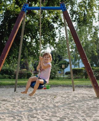 Girls playing outdoors on the swing