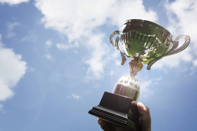 Celebrating with trophy award for success or first place sporting championship win