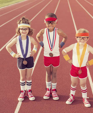 Three little track champions show off their medals.