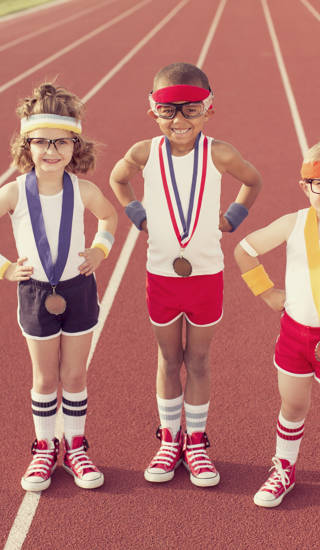 Three little track champions show off their medals.