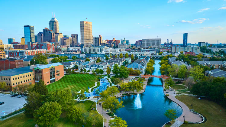 Aerial View of Vibrant Indianapolis Cityscape with Serene Park and Waterway at Golden Hour