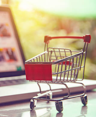 Shopping online concept - shopping cart or trolley on a laptop keyboard. Shopping service on The online web.