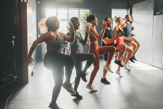 Diversity in gym class doing workout, training and exercise. Multicultural, happy and diverse people with different body shape and size exercising and active at a gym for fitness, wellness and cardio