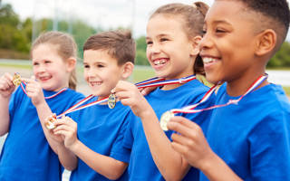 Children Showing Off Winners Medals On Sports Day
