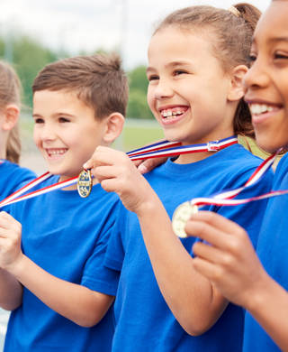 Children Showing Off Winners Medals On Sports Day