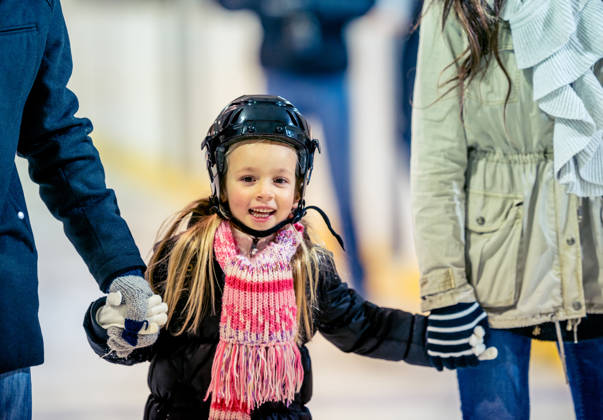 Having a good time at an ice skating arena.