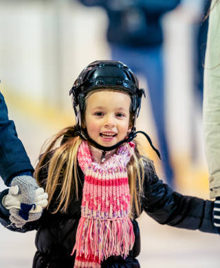 Having a good time at an ice skating arena.