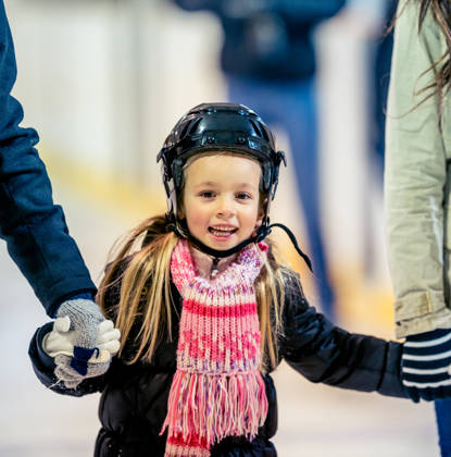 Having a good time at an ice skating arena.