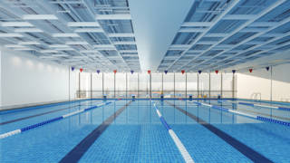 Close-up View Of Olympic Swimming Pool With Cityscape Through The Window