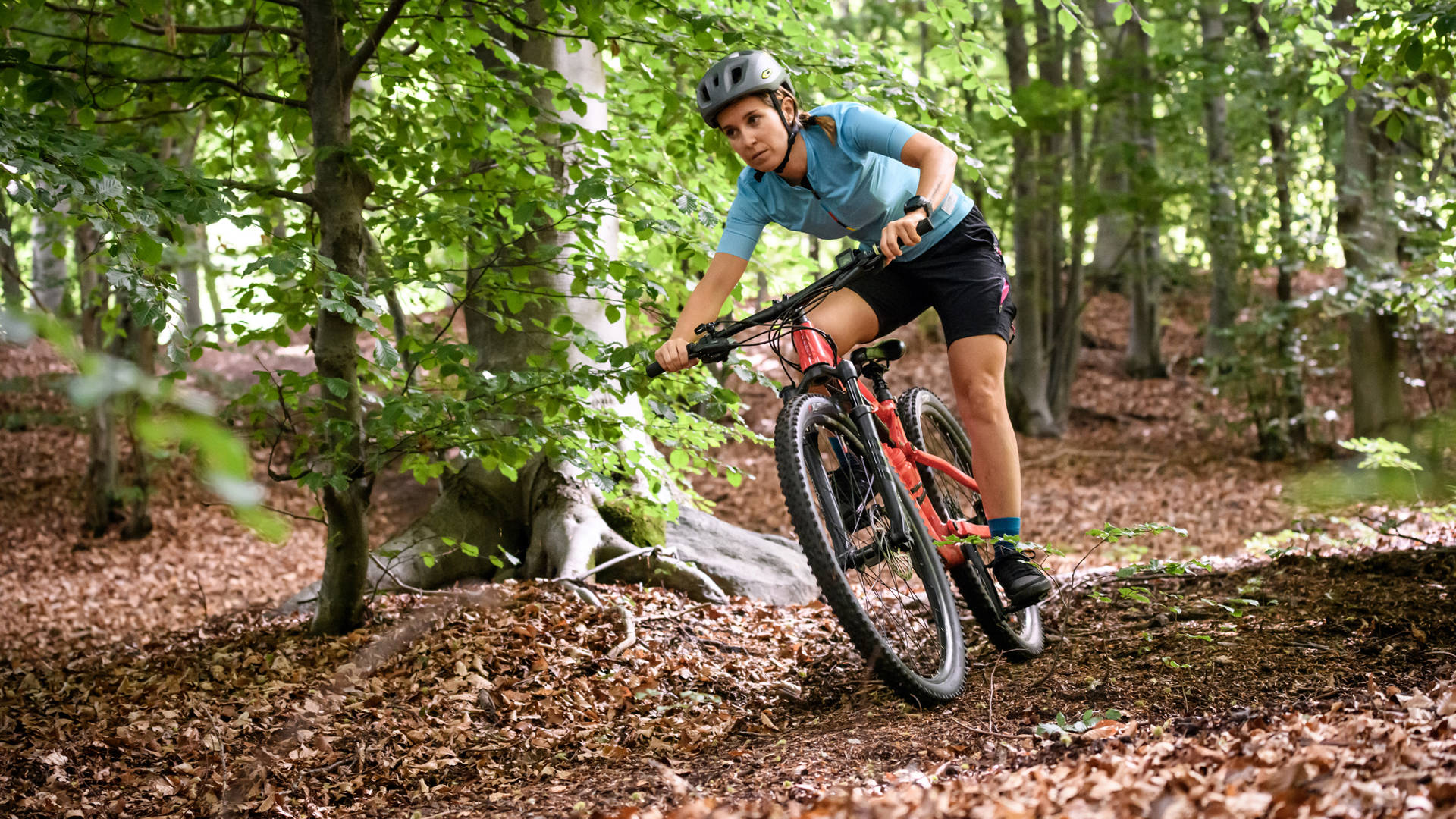 Young woman with mountain bike on Italian mountains: Downhill in the forest