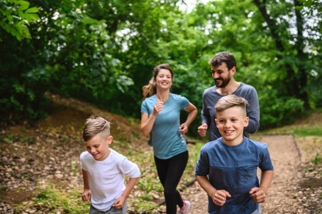 Portrait of happy family exercise running in the park spring time. Health care together love lifestyle concept