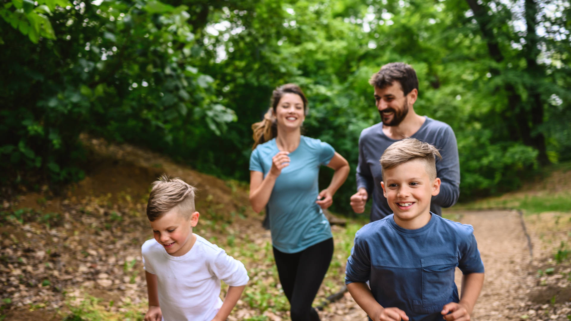 Portrait of happy family exercise running in the park spring time. Health care together love lifestyle concept