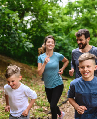Portrait of happy family exercise running in the park spring time. Health care together love lifestyle concept