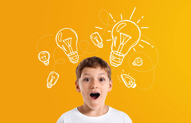 Excited boy with amazed expression, surrounded by white lightbulb sketches, on a bright orange background, representing creativity and inspiration