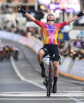 Belgian Lotte Kopecky of SD Worx celebrates as she crosses the finish line to win the women's one-day cycling race Omloop Het Nieuwsblad, for the first time part of the Women's World Tour races, 132,2 km from Gent to Ninove, Saturday 25 February 2023. BELGA PHOTO TOM GOYVAERTS