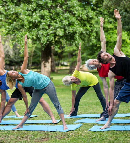 Fitness class stretching in the park