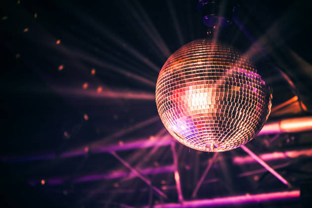 Disco ball with bright rays, night party background photo