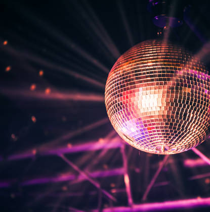 Disco ball with bright rays, night party background photo