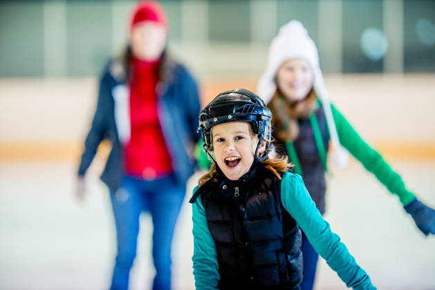 Having a good time at an ice skating arena.