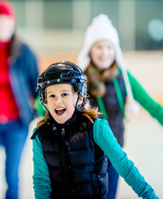 Having a good time at an ice skating arena.