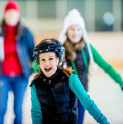 Having a good time at an ice skating arena.