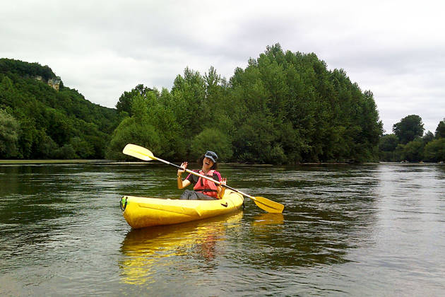Happy girl in a canoe with a oar