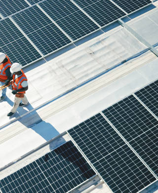 Renewable energy, solar panels and team walking on roof planning for inspection at sustainable business. Engineering, sustainability and photovoltaic power on rooftop, men in electricity maintenance.