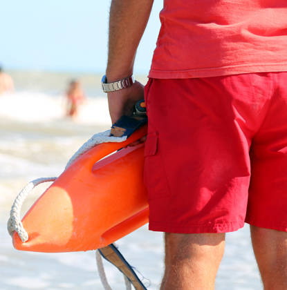 muscled lifeguard with the rescue can to rescue the swimmers in case of drowning