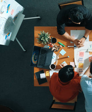 Top view of smart business man put scrum board on table at meeting room while marketing team preparing marker and sticky notes for making task board for managing work flow in work place. Convocation.