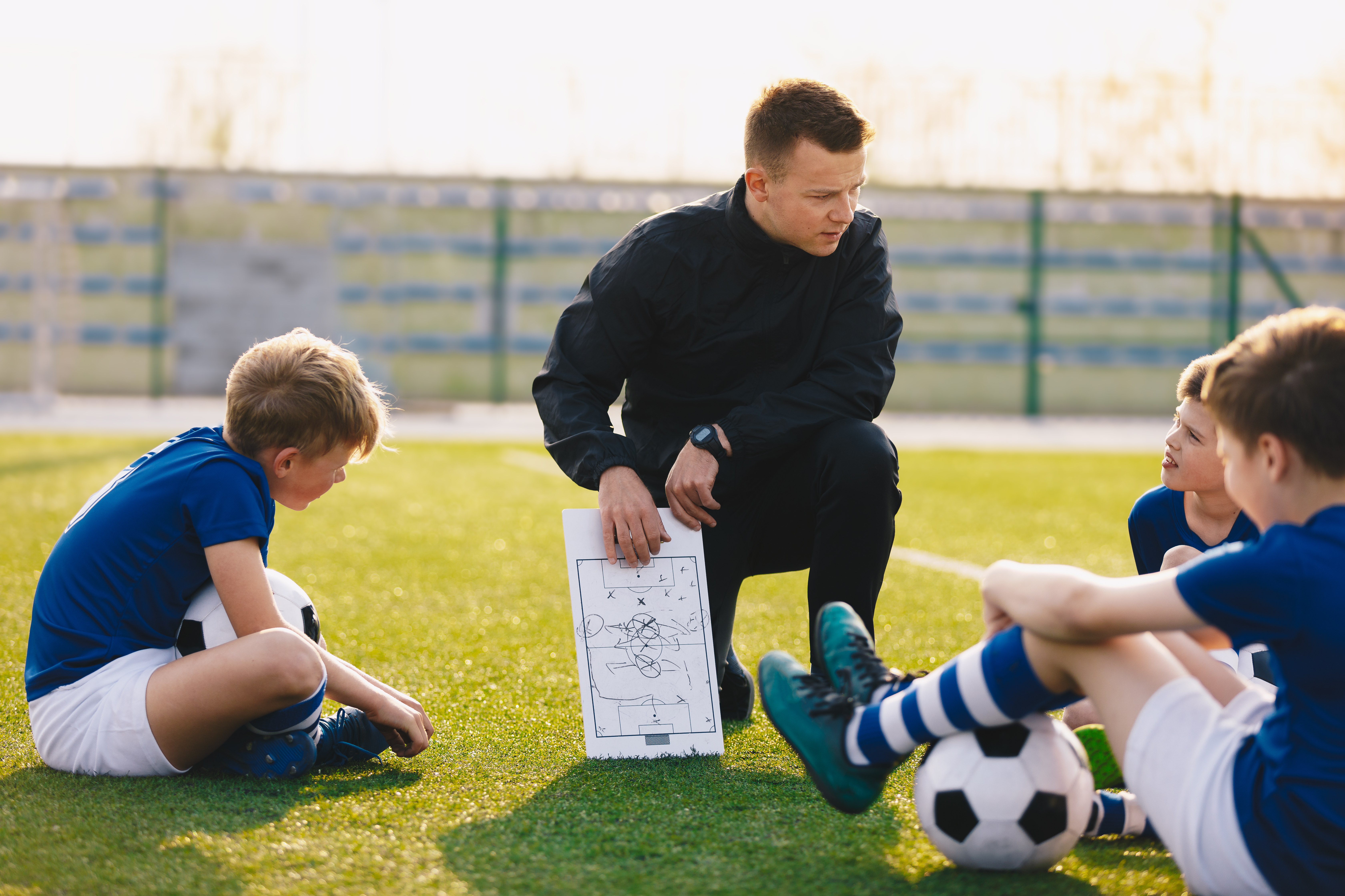 Coach legt tactiek uit aan jonge voetballertjes