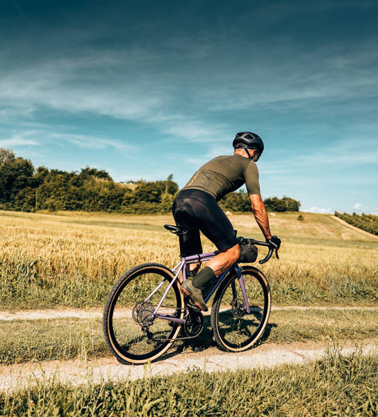 cyclist with gravel bike in italy in the countryside