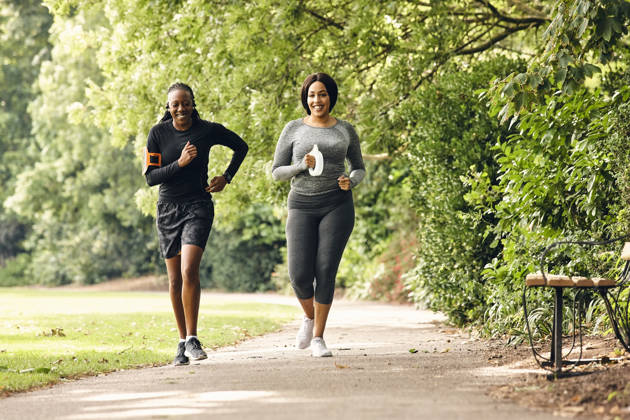Two healthy women running at morning in the park.